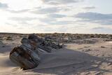 Wrecked piece of hull buried in sand